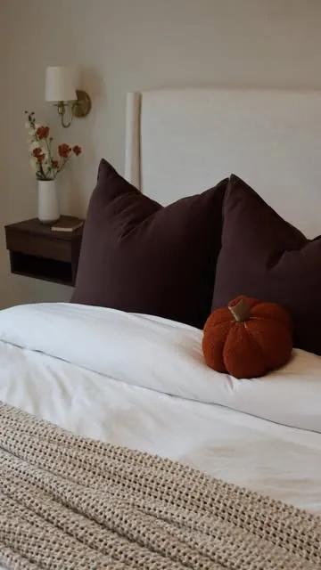 Cozy neutral bedroom styled with a velvet pumpkin