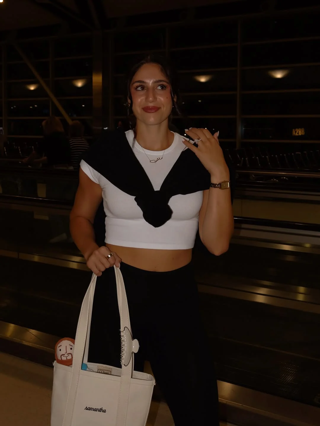 Samantha at a pilates studio holding a tote bag